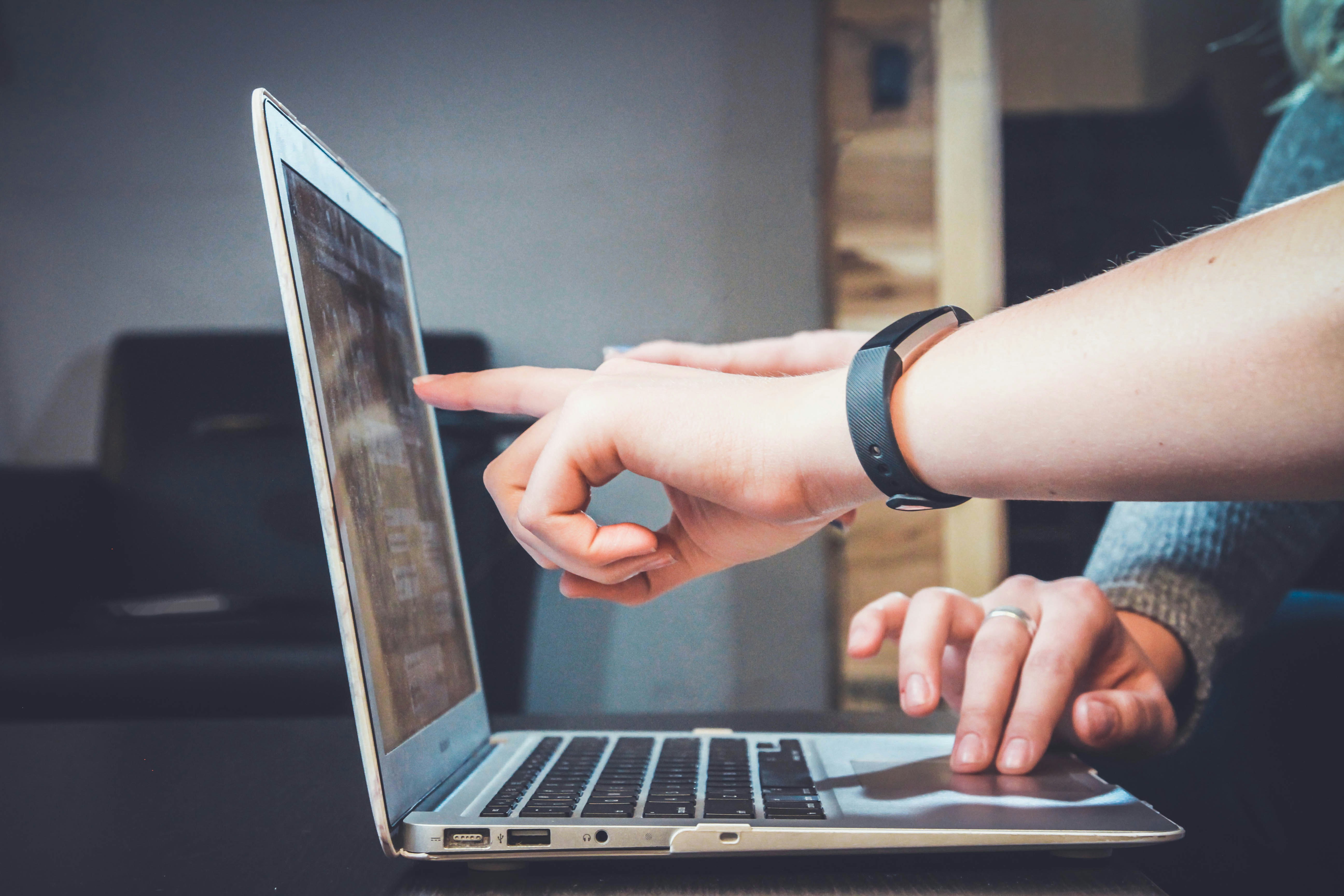 Persons Pointing on a Laptop - Customer Journey Management